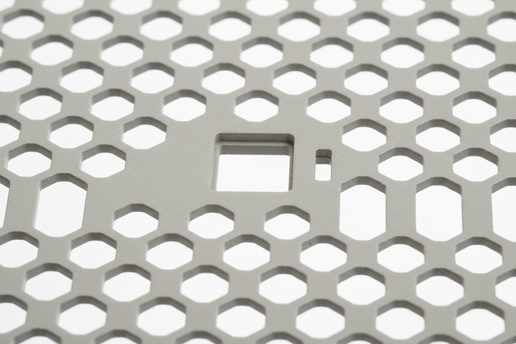 Knurr 2U Vented Blanking Panel — Close-up of 30% perforation pattern, M6 cage nut mounting hole, and RAL 7035 edge finish